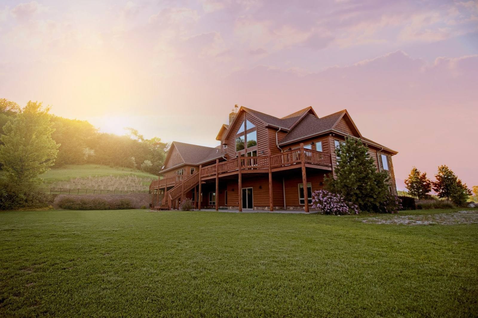 Illustrative timber-sided home with a deck and surrounding lawn; not an identified St. Mary’s City listing