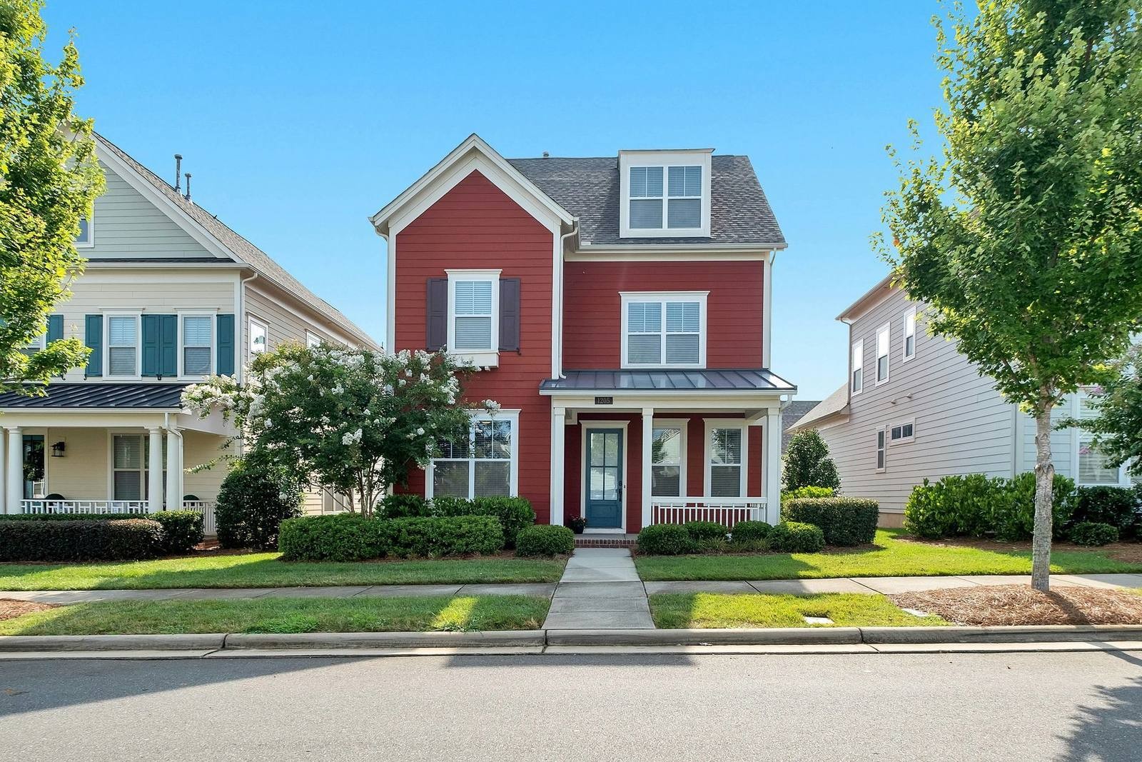 Illustrative red-sided house with a front porch and landscaped yard; not an identified Valley Lee listing